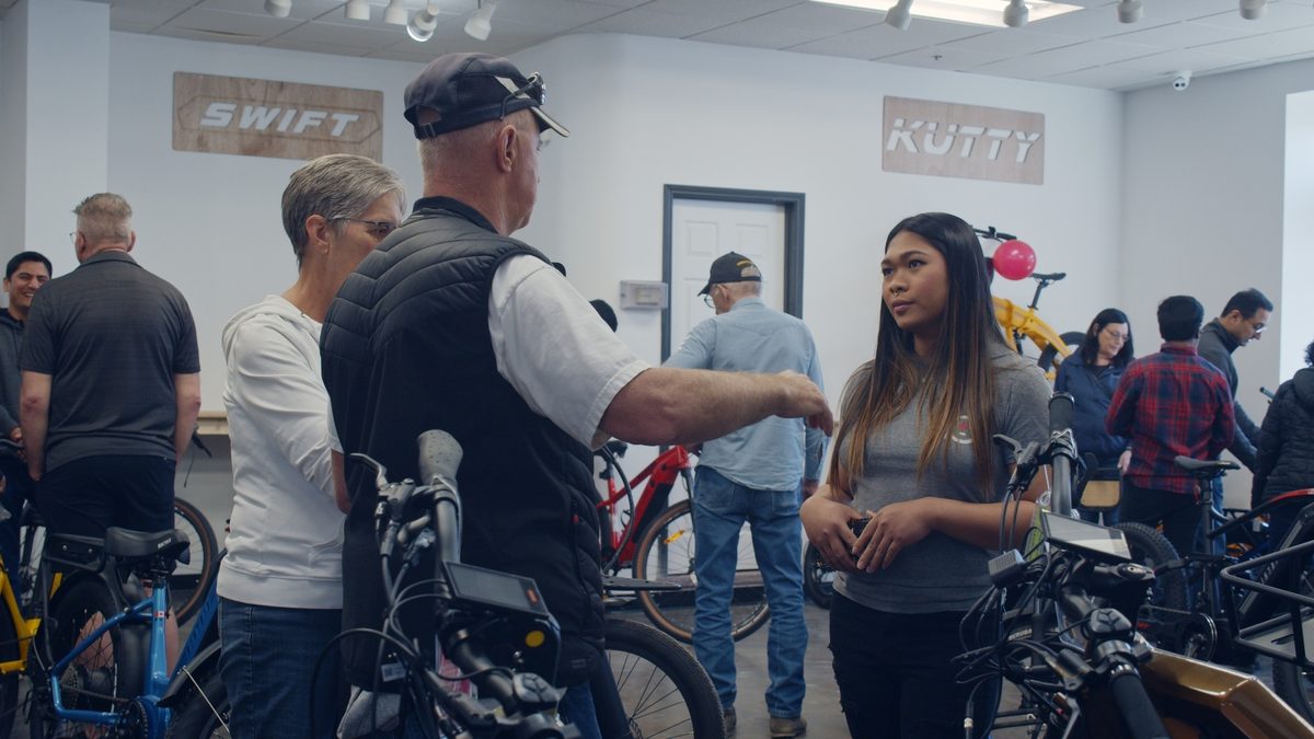 Biktrix staff talking with customers among the bikes on the showroom floor