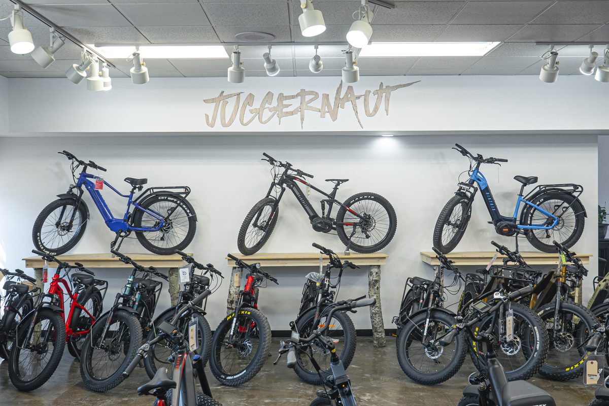 Juggernaut models mounted on the showroom wall above a row of bikes on the floor